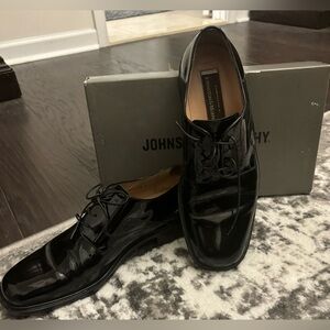 Johnston & Murphy black patent leather tuxedo shoes.
